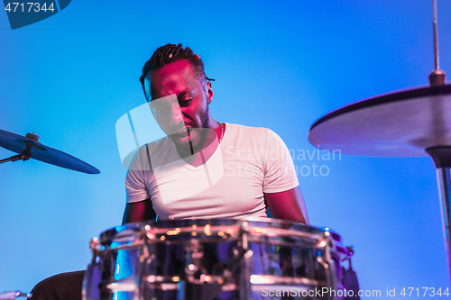 Image of Young african-american jazz musician playing drums