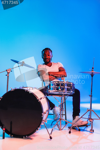 Image of Young african-american jazz musician playing drums