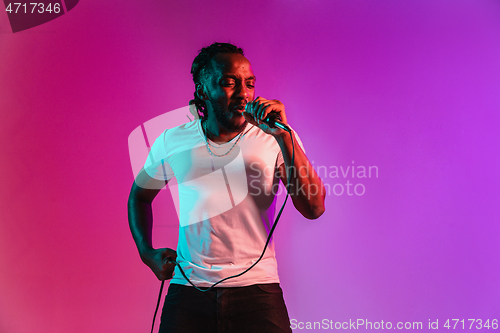 Image of Young african-american jazz musician singing a song