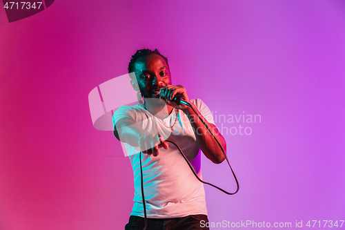 Image of Young african-american jazz musician singing a song