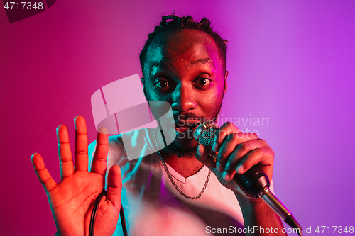 Image of Young african-american jazz musician singing a song