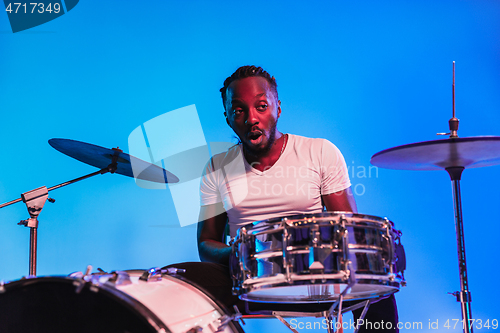 Image of Young african-american jazz musician playing drums