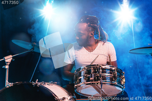 Image of Young african-american jazz musician playing drums