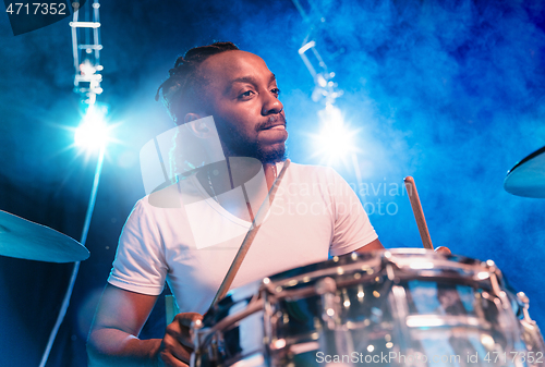 Image of Young african-american jazz musician playing drums