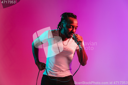 Image of Young african-american jazz musician singing a song