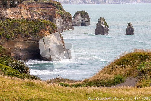 Image of sea shore rocks and mount Taranaki, New Zealand