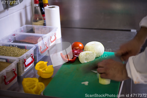 Image of Chef hands cutting fresh and delicious vegetables