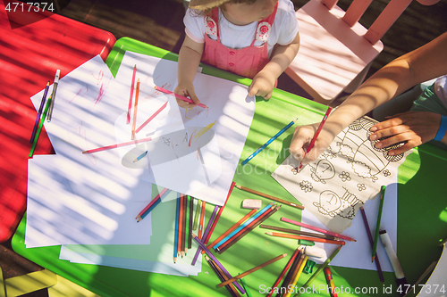 Image of mom and little daughter drawing a colorful pictures