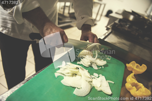 Image of Chef hands cutting fresh and delicious vegetables