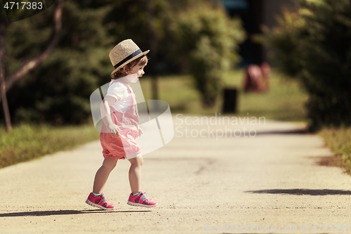 Image of little girl runing in the summer Park