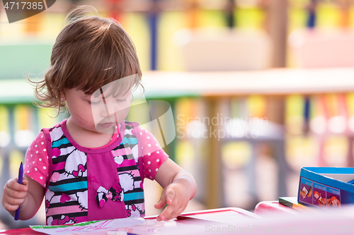 Image of little girl drawing a colorful pictures