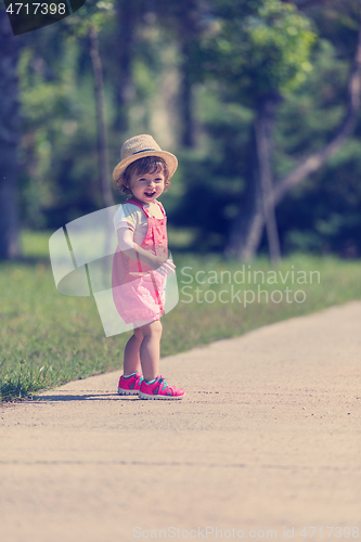 Image of little girl runing in the summer Park