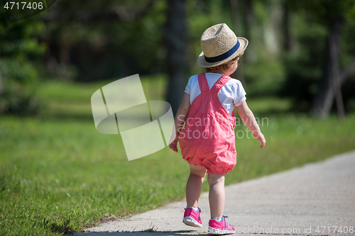 Image of little girl runing in the summer Park