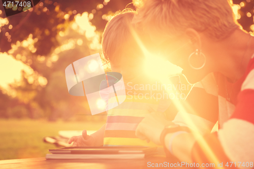 Image of mom and her little daughter using tablet computer