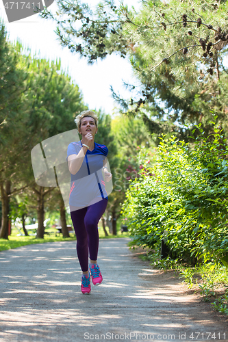 Image of young female runner training for marathon