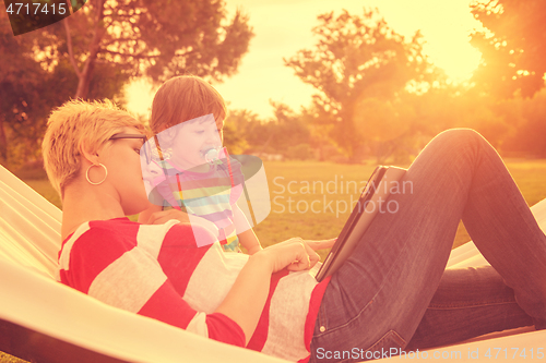 Image of mom and a little daughter relaxing in a hammock