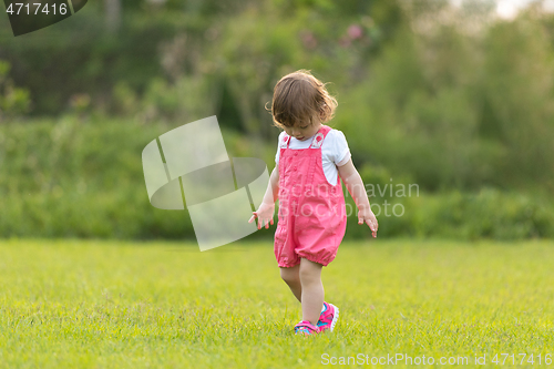 Image of little girl spending time at backyard