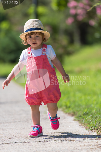 Image of little girl runing in the summer Park