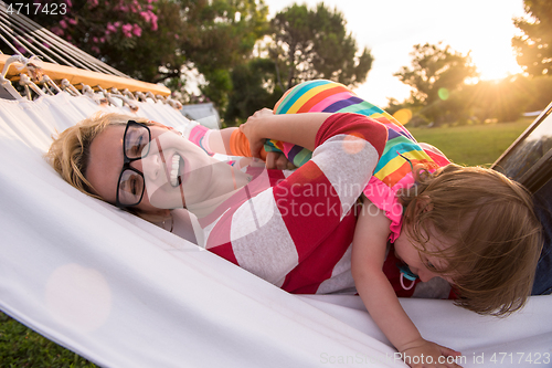 Image of mom and a little daughter relaxing in a hammock