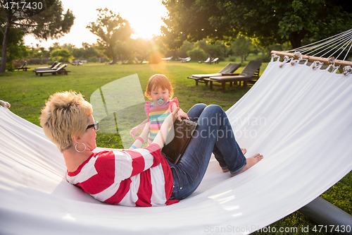 Image of mom and a little daughter relaxing in a hammock