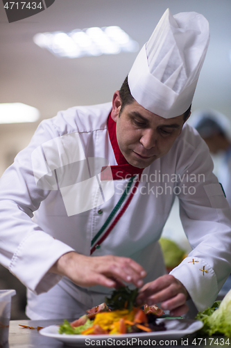 Image of chef serving vegetable salad