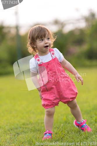 Image of little girl spending time at backyard