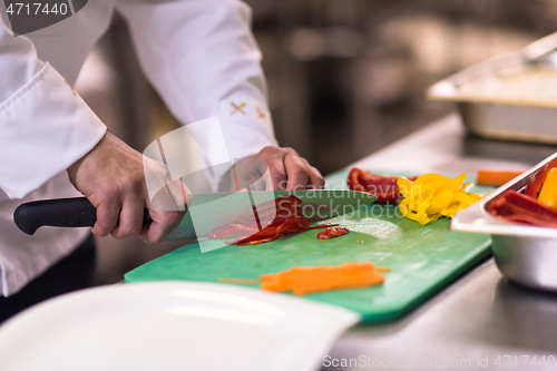 Image of Chef hands cutting fresh and delicious vegetables