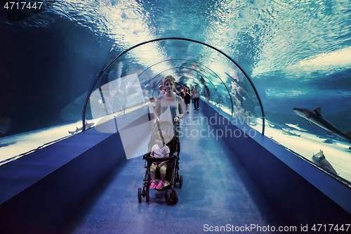 Image of happy family  in the underwater aquarium