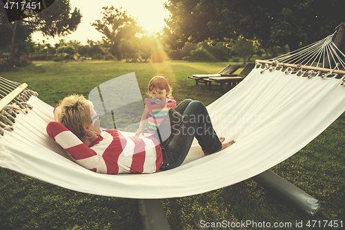 Image of mom and a little daughter relaxing in a hammock