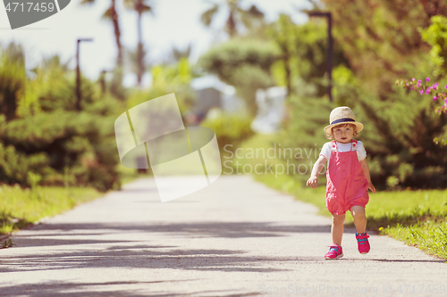 Image of little girl runing in the summer Park