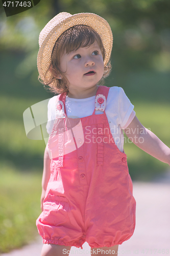 Image of little girl runing in the summer Park