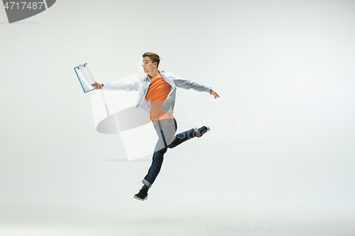 Image of Man working at office and jumping isolated on studio background