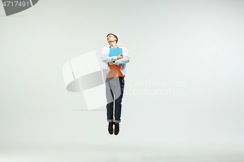 Image of Man working at office and jumping isolated on studio background