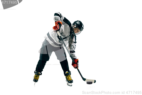 Image of Young female hockey player with the stick isolated on white background