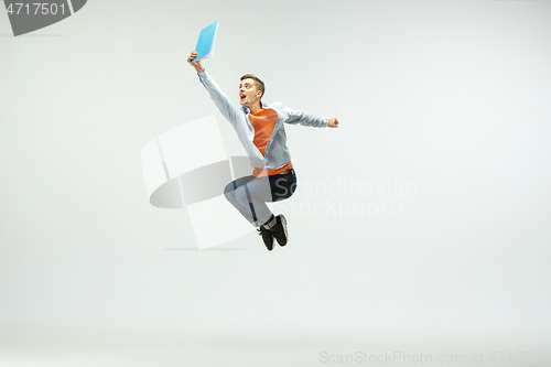 Image of Man working at office and jumping isolated on studio background