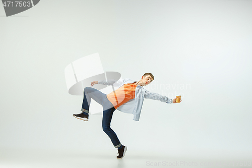 Image of Man working at office and jumping isolated on studio background