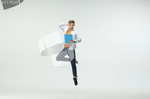 Image of Man working at office and jumping isolated on studio background