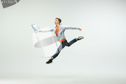 Image of Man working at office and jumping isolated on studio background