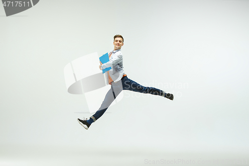 Image of Man working at office and jumping isolated on studio background