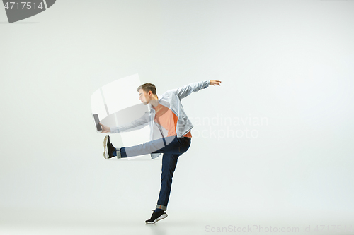 Image of Man working at office and jumping isolated on studio background