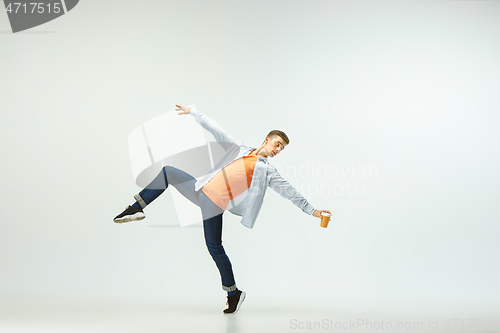 Image of Man working at office and jumping isolated on studio background