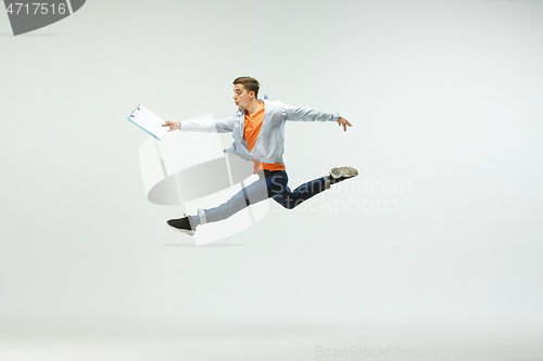 Image of Man working at office and jumping isolated on studio background