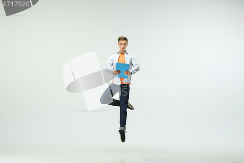 Image of Man working at office and jumping isolated on studio background