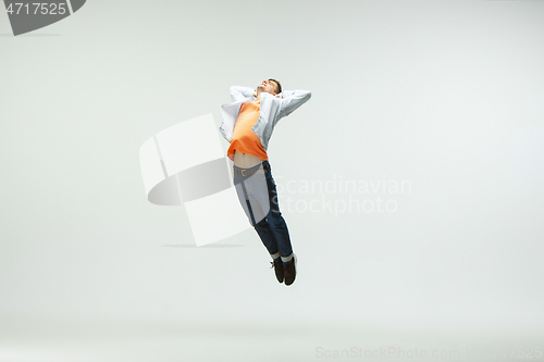 Image of Man working at office and jumping isolated on studio background