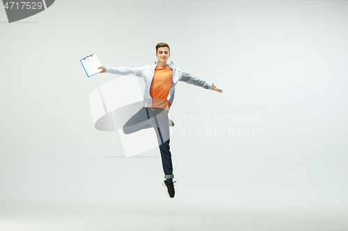 Image of Man working at office and jumping isolated on studio background