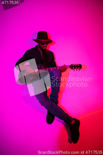 Image of Young african-american jazz musician playing the guitar