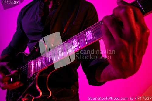 Image of Young african-american jazz musician playing the guitar