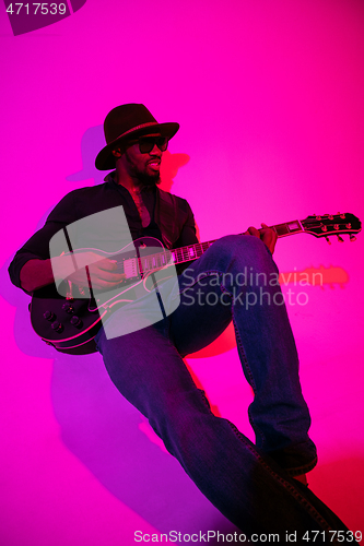 Image of Young african-american jazz musician playing the guitar