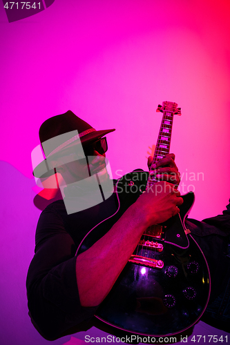 Image of Young african-american jazz musician playing the guitar