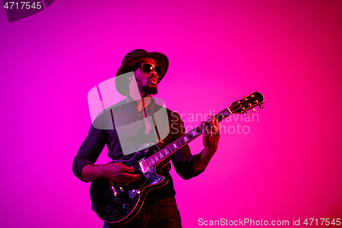 Image of Young african-american jazz musician playing the guitar